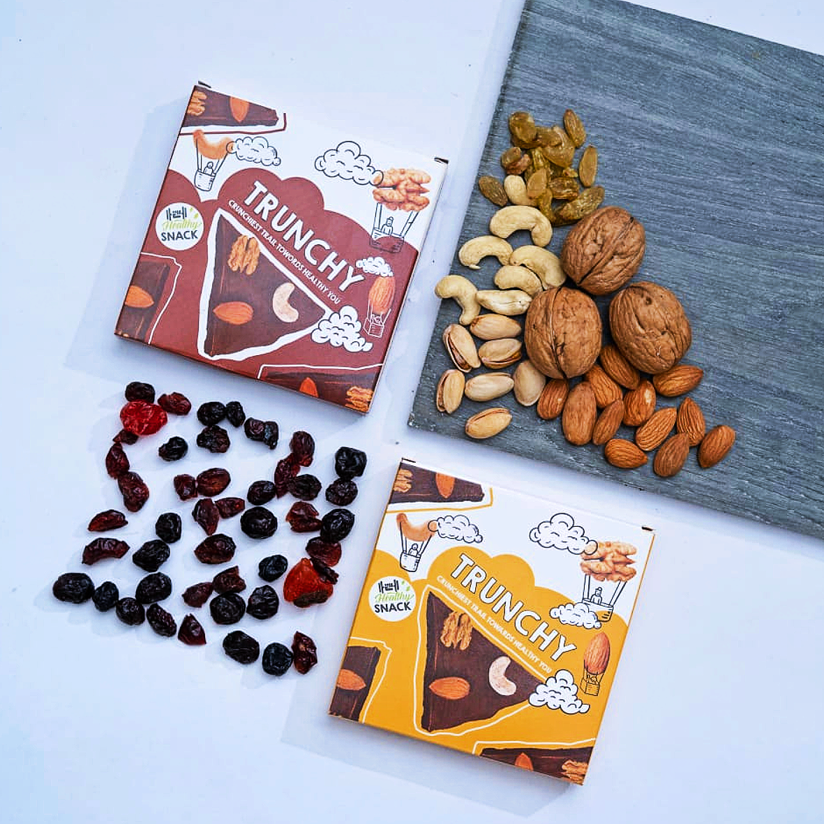 Trunchy packaging alongside premium ingredients: walnuts, Almonds, Cashews, Pistachio, Raisin, Blue berry, raspberry , strawberry,  dark chocolate, chia seeds, berries, coconut oil, dates, and melon seeds. Healthy snacking redefined.